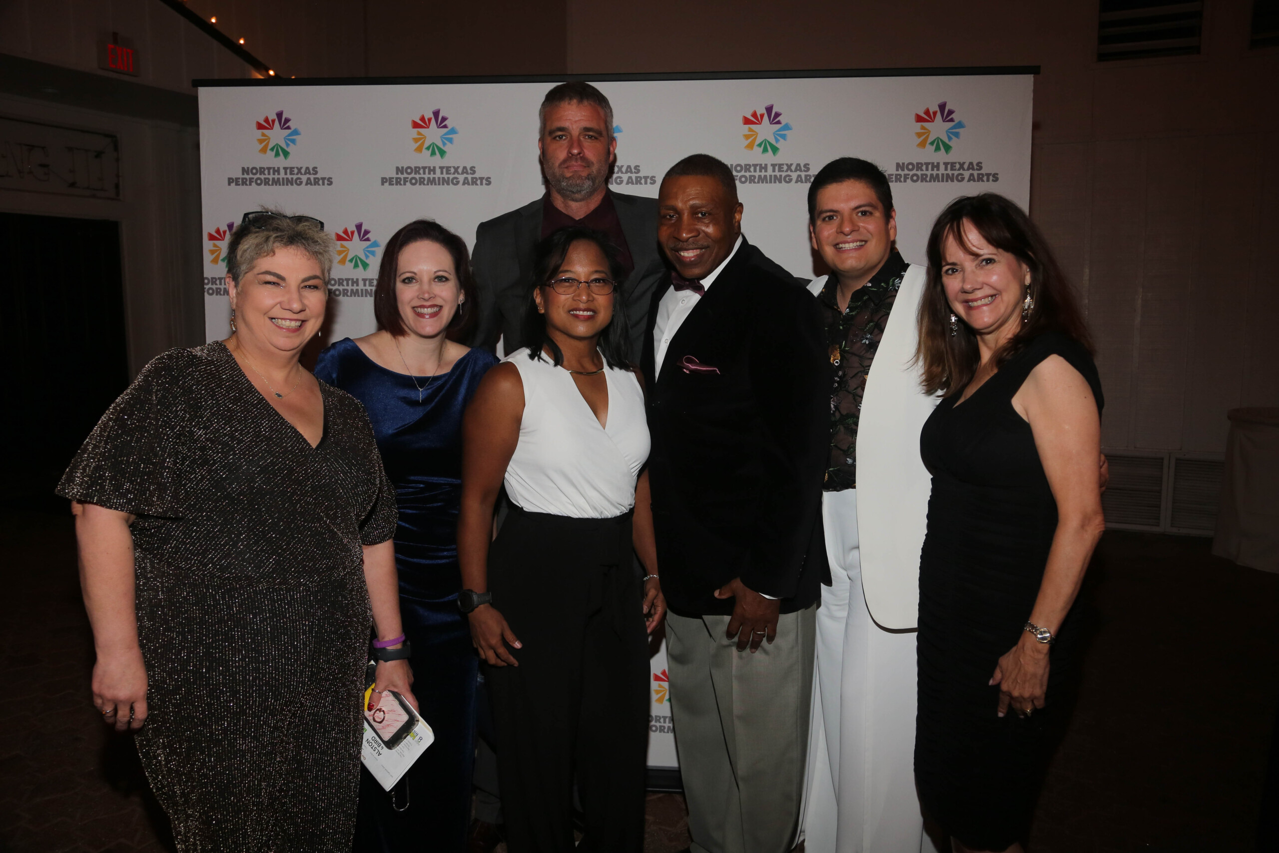 NTPA volutneers pose in front of an NTPA set and repeat banner at the annual Stardust awards gala