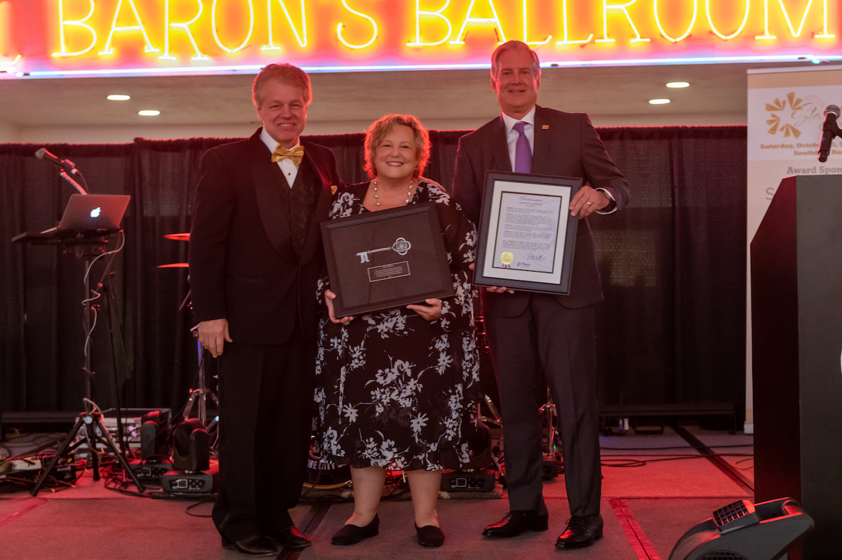 Darrell Rodenbaugh, Sara Akers, and John B Muns pose for a photo