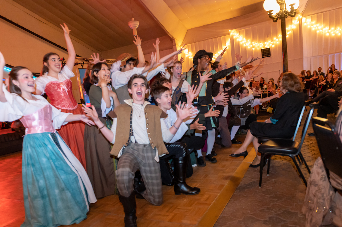 Collegiate Pursuits students post at the end of a performance at the 2022 Stardust Awards