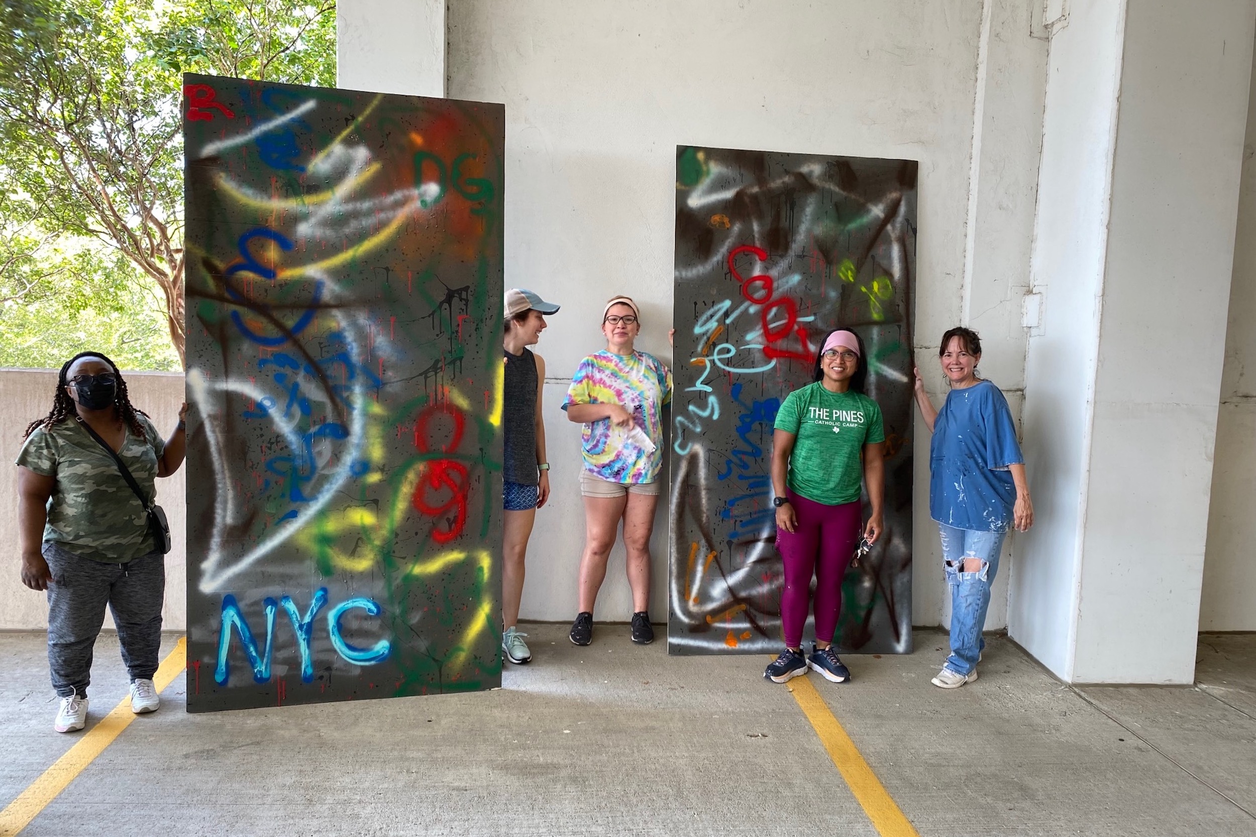 Volunteers show off painted set pieces